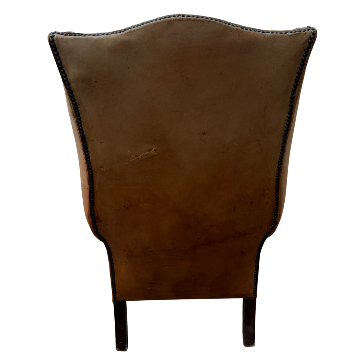 Worn wooden cabriole front legs and stretcher on a vintage leather Chesterfield-style chair