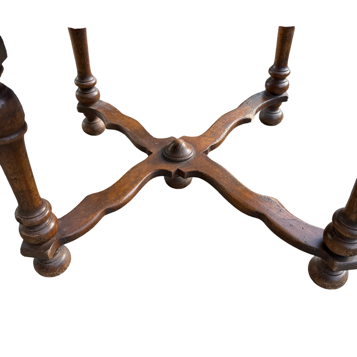 Row of vintage dining chairs upholstered in red fabric with carved turned wooden legs