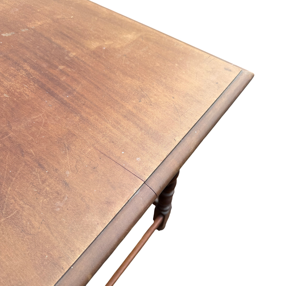 Close-up of surface wear and scratches on the vintage table top edge