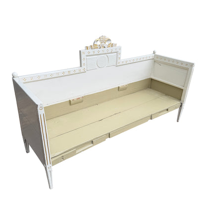 Lower view of daybed base showing three panel fronts and legs