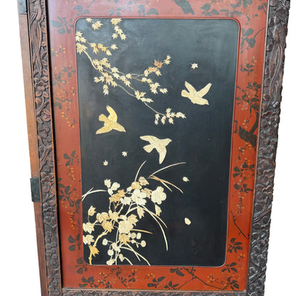 Close-up showing carved wooden frame and decorative top of two-panel folding screen