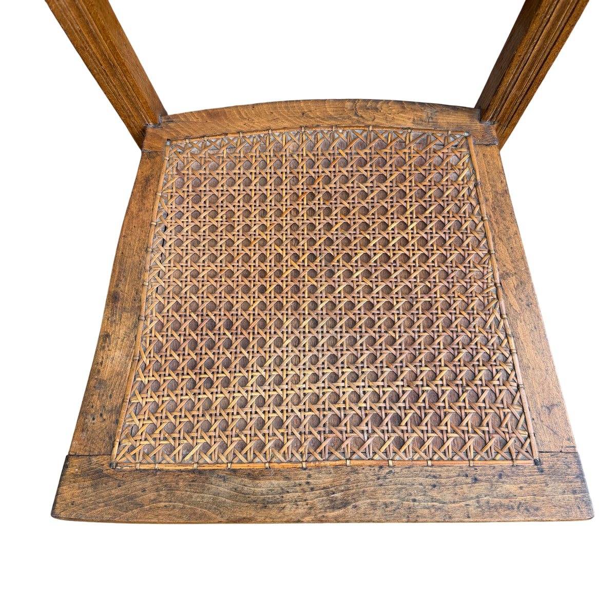 Side view of hardwood ladderback chair showing turned front leg
