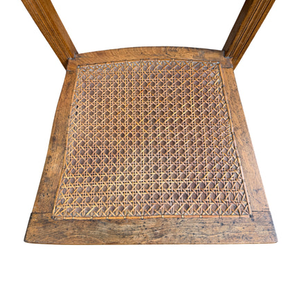 Side view of hardwood ladderback chair showing turned front leg