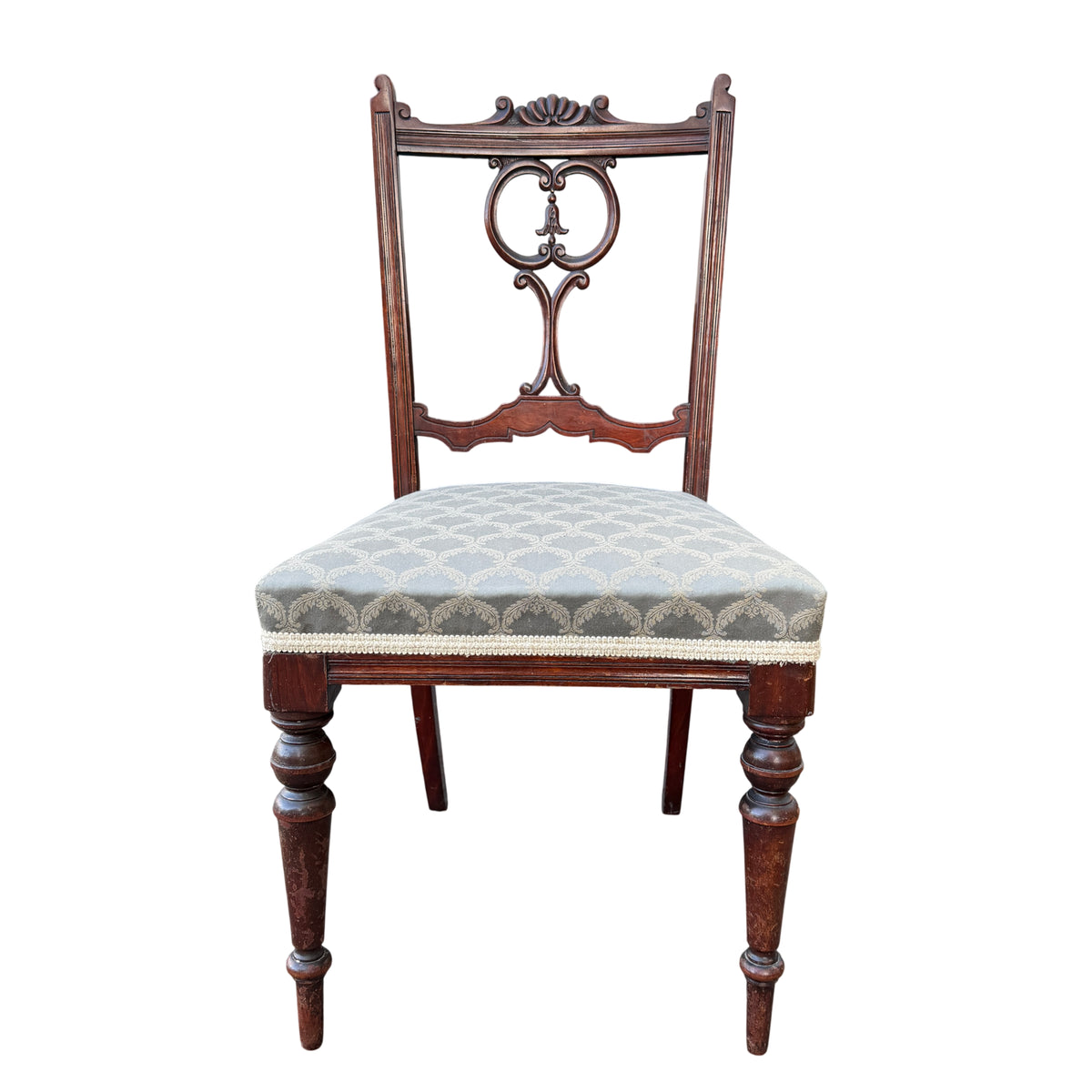 Edwardian mahogany chair showing carved shell crest and pierced scroll back detail