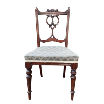 Edwardian mahogany chair showing carved shell crest and pierced scroll back detail