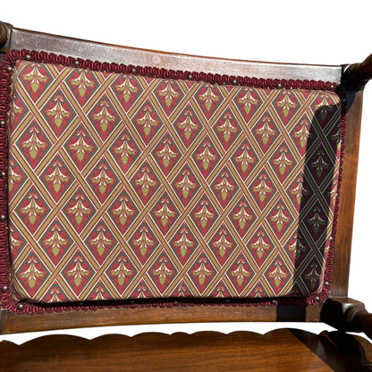 Close-up of scalloped top backboard on a vintage wooden armchair