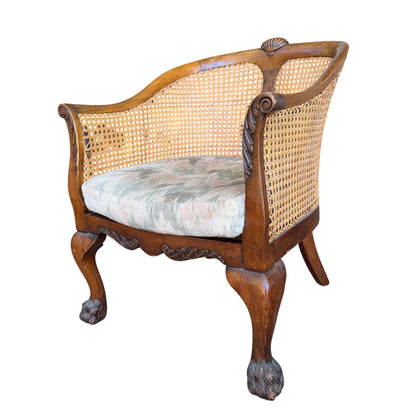 Side view vintage cane-back armchair showing carved scroll arm and cane panels
