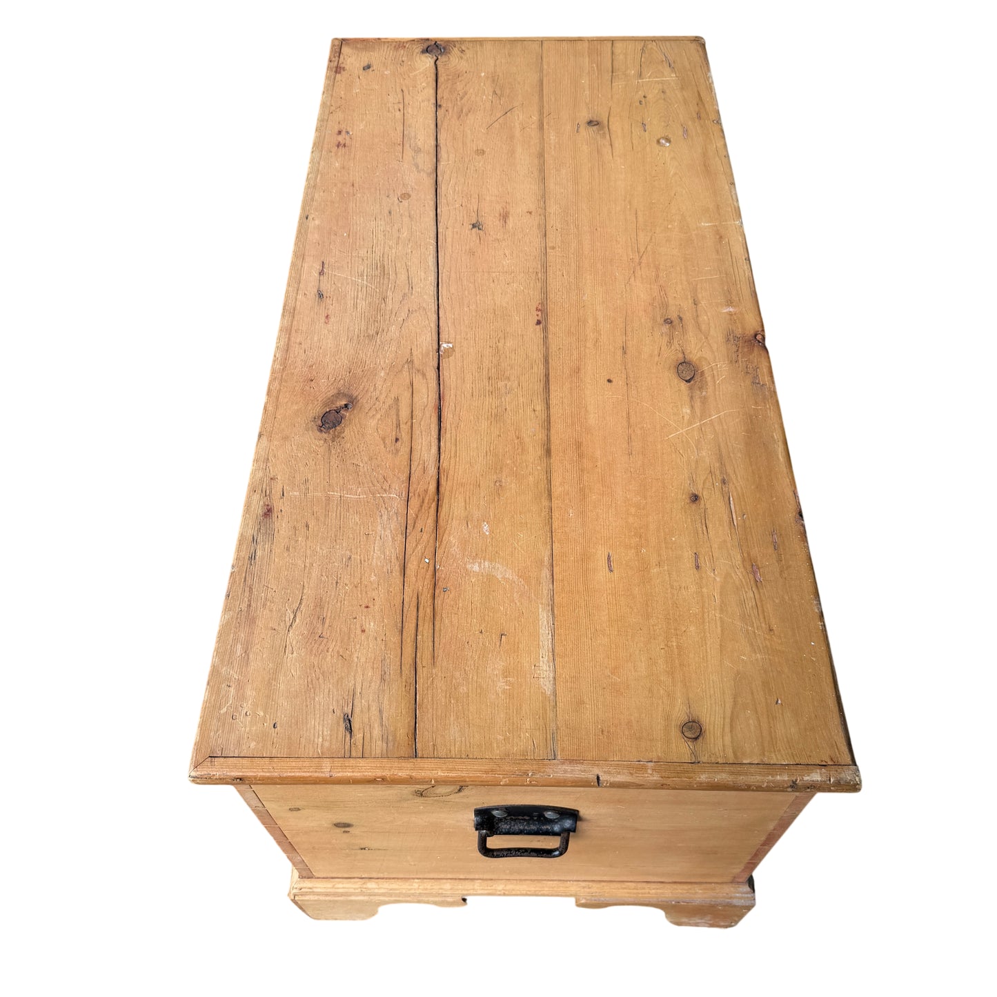 Top view of pine chest lid with visible plank joints and rounded edge
