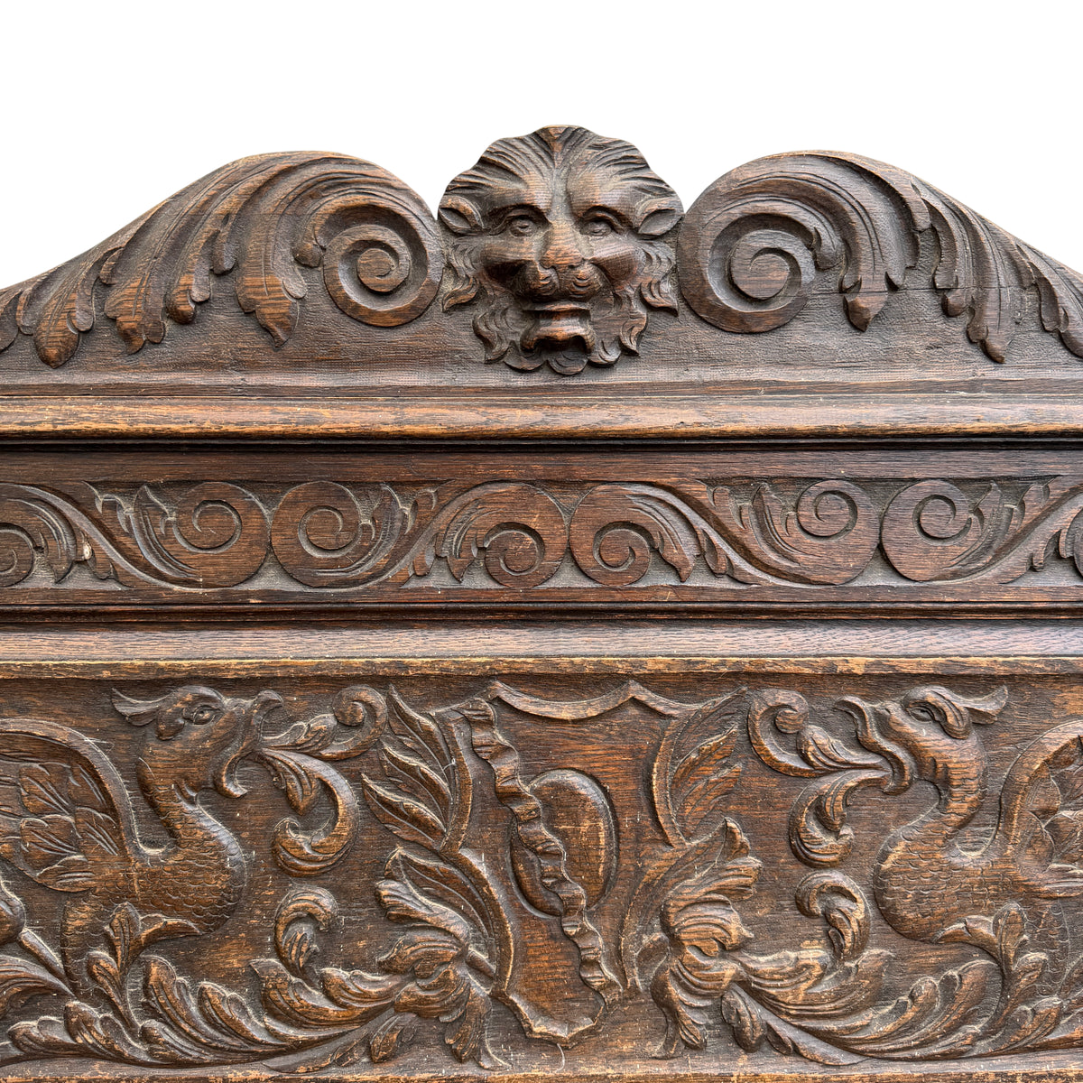 Side view of carved upright with mythical beast figure on oak bench