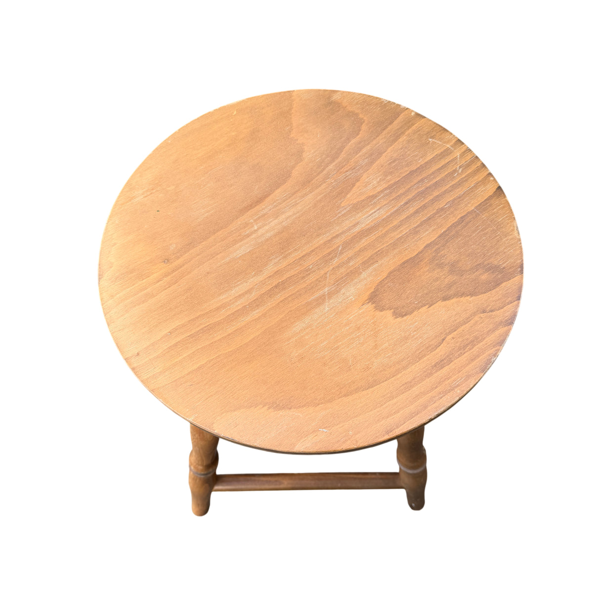 Side view of wooden stool showing turned legs and connecting stretchers