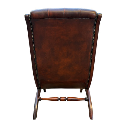 Base and leg detail of mahogany frame on Chesterfield-style slipper chair