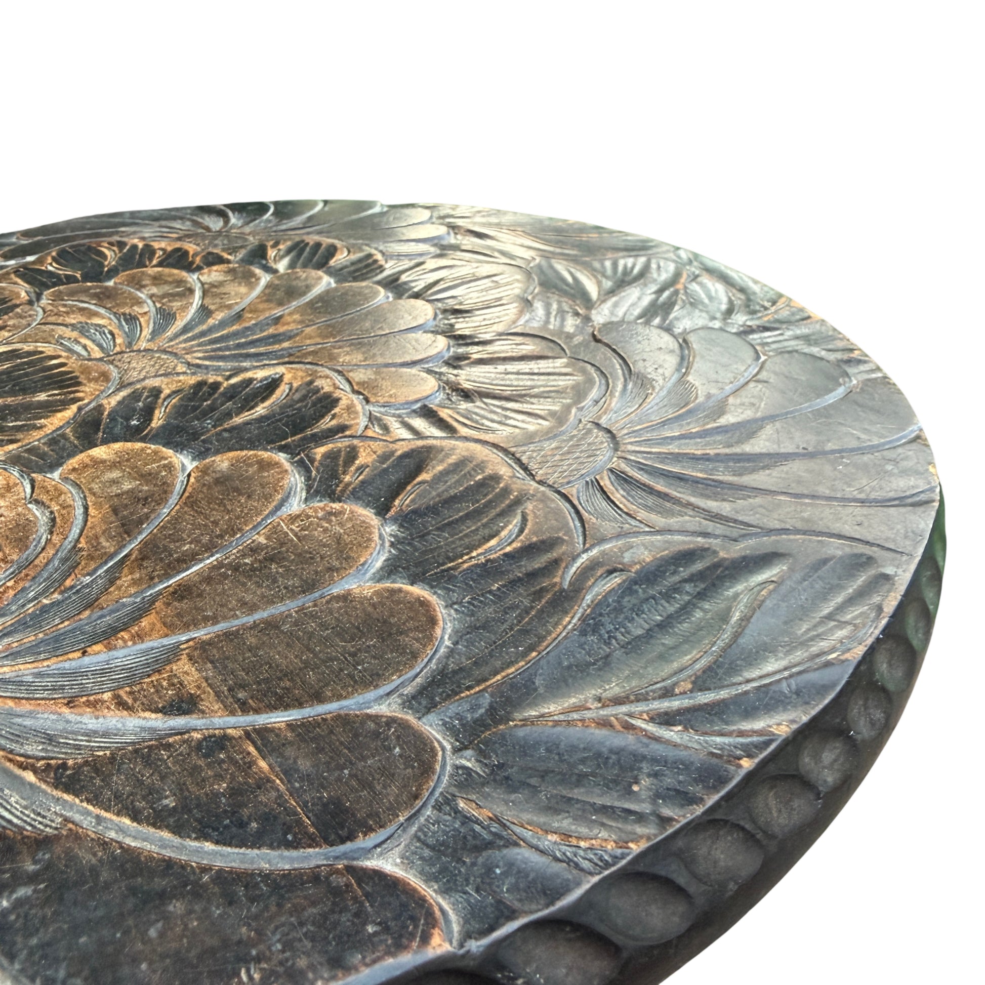 Detail of round carved floral top on a vintage hardwood side table