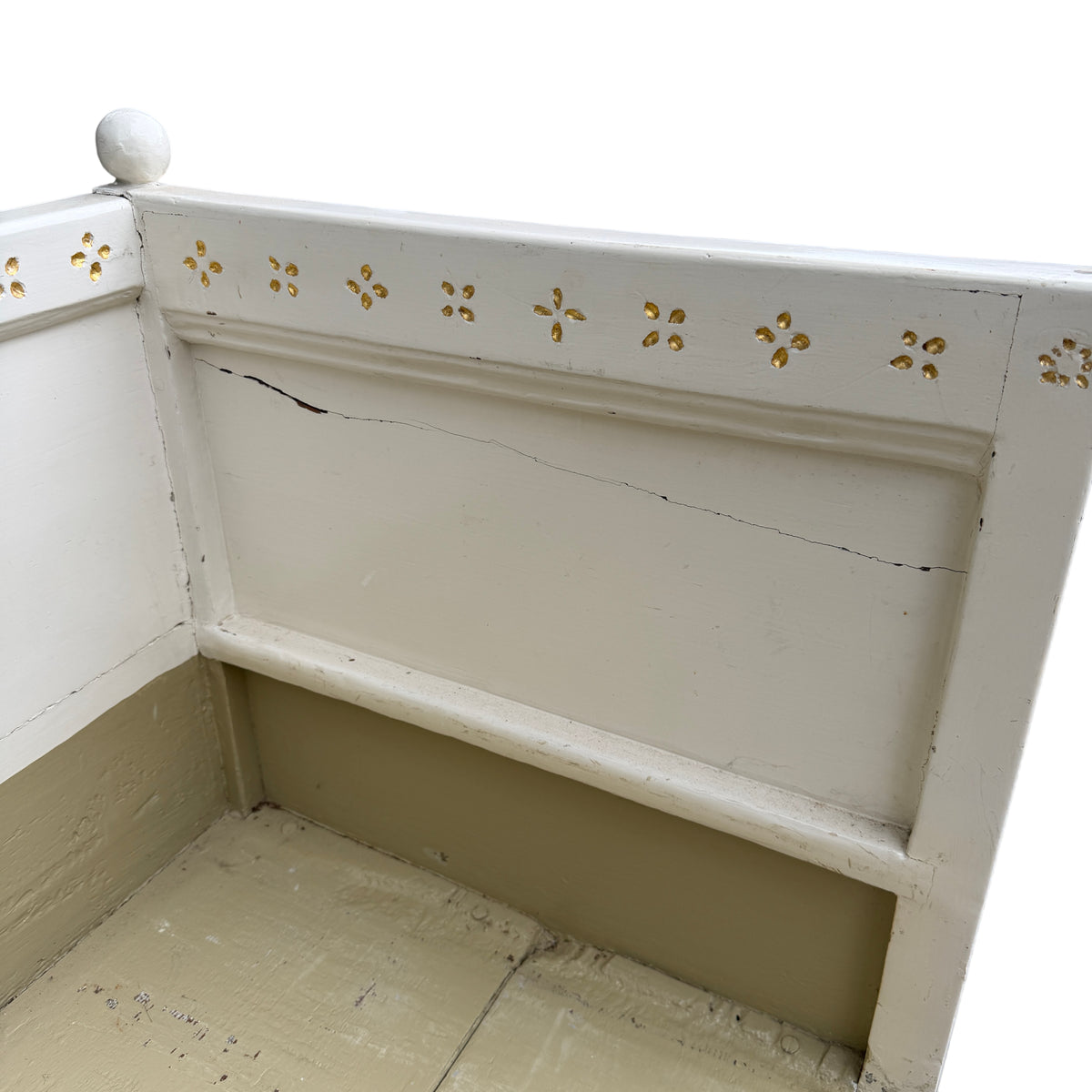 Paint chipping and scuffs visible on leg and corner of painted daybed