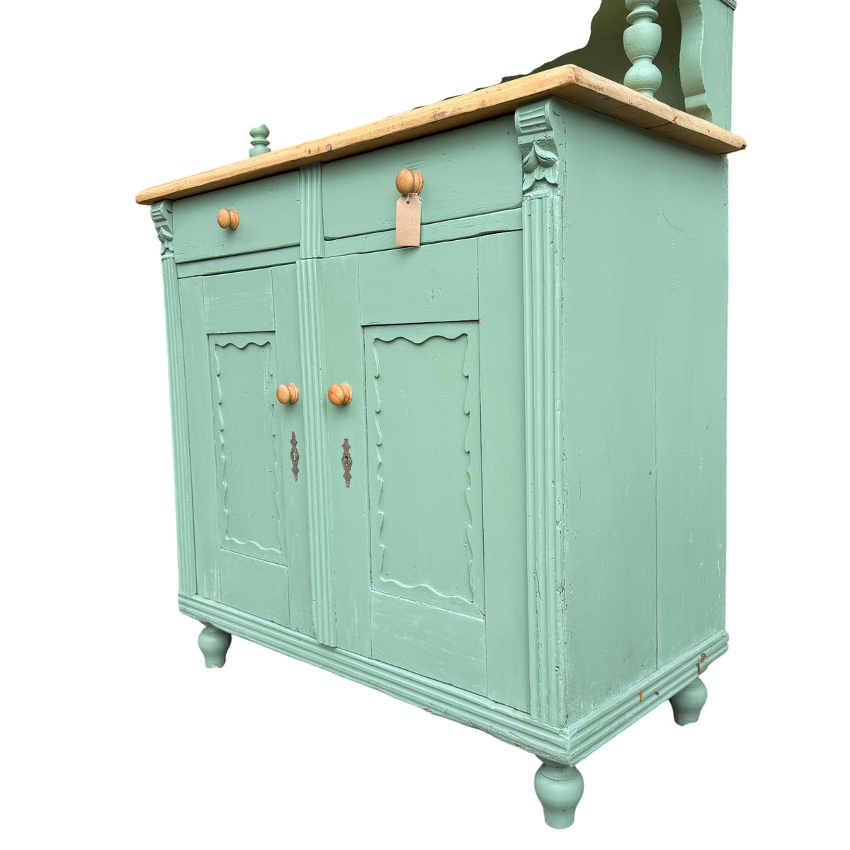 Green painted pine storage cabinet with wooden knobs and lower cupboard doors