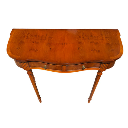 Bowed-front hall table with two small drawers and brass cup knobs