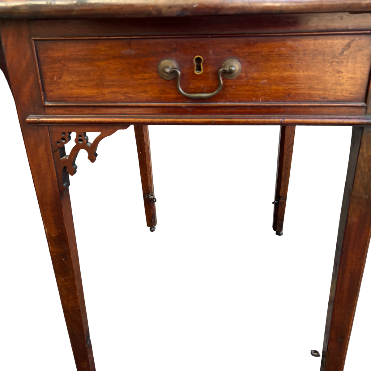 Top surface of vintage drop-leaf table with visible marks and warm finish