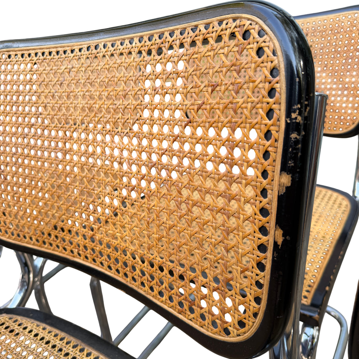 Three chairs in the set with visible breaks and holes in the cane seats requiring repair or re-caning