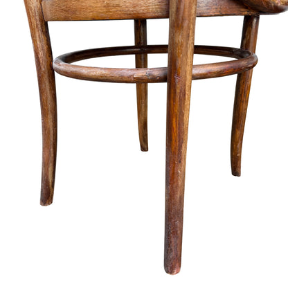 Curved wooden back rail detail on a vintage bistro chair