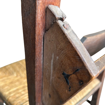 Lower view showing stretchers and scuffed legs on rustic dining chair