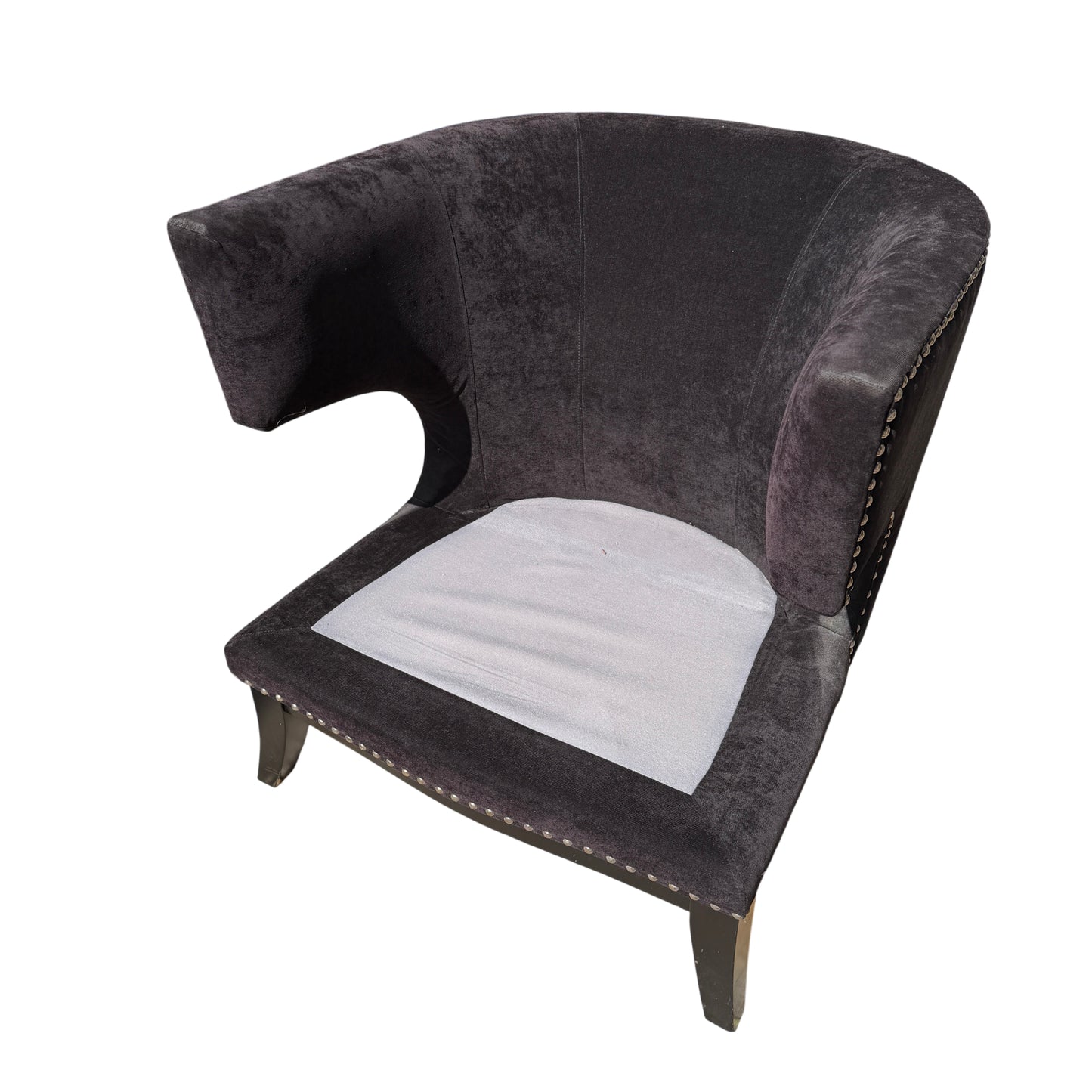 Detailed view of winged arm shape on a dark upholstered lounge chair
