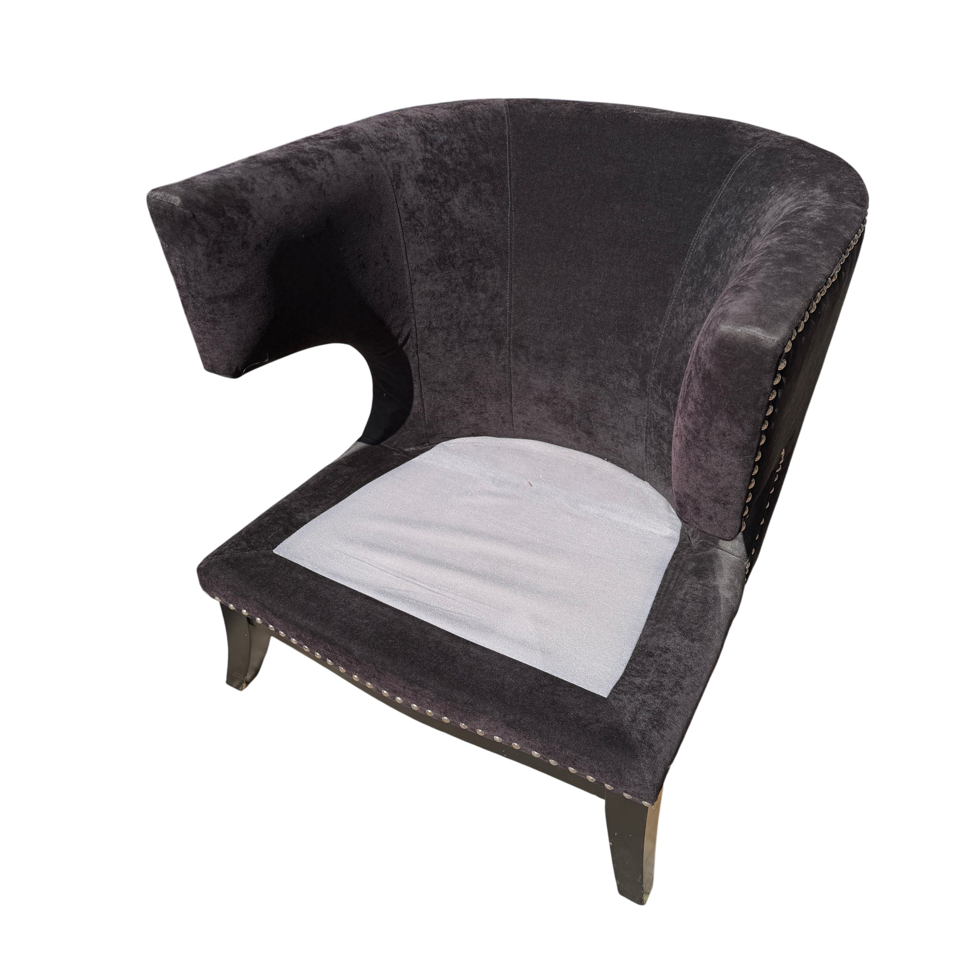 Detailed view of winged arm shape on a dark upholstered lounge chair