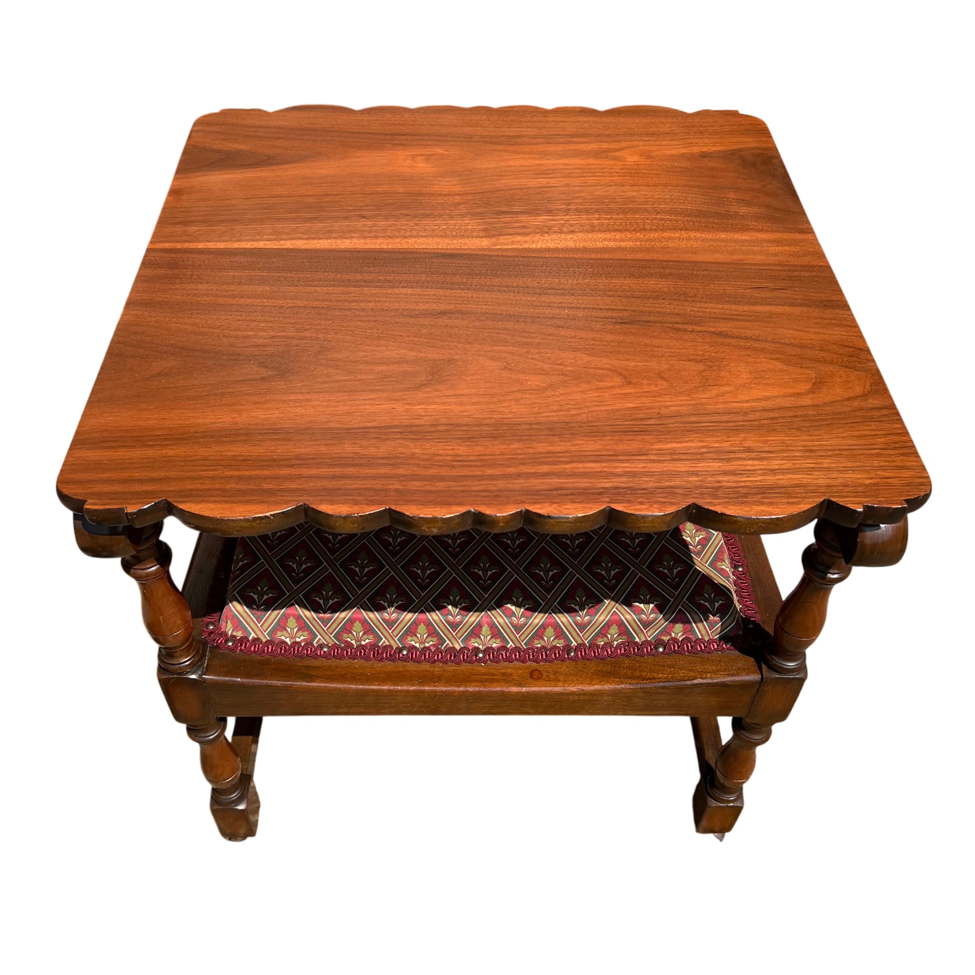 Side view of wooden armchair armrest and turned leg on a textured stone floor