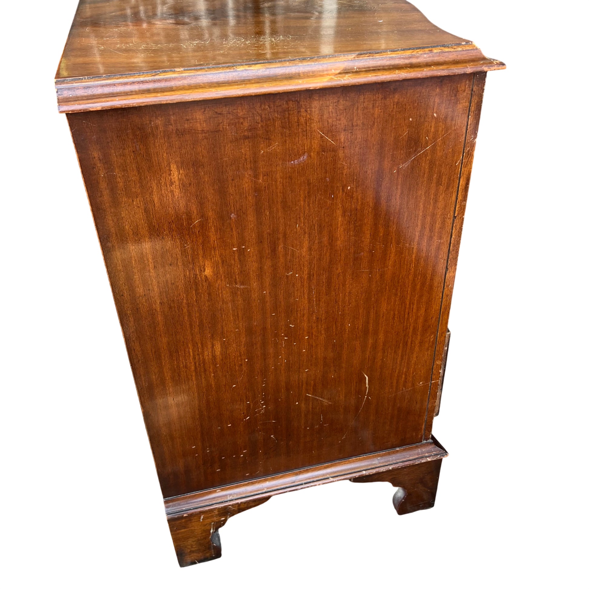 Close up of brass ring drawer handle on vintage mahogany chest
