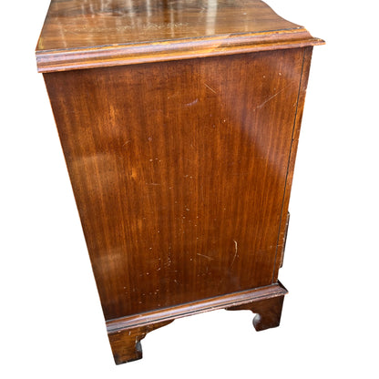 Close up of brass ring drawer handle on vintage mahogany chest