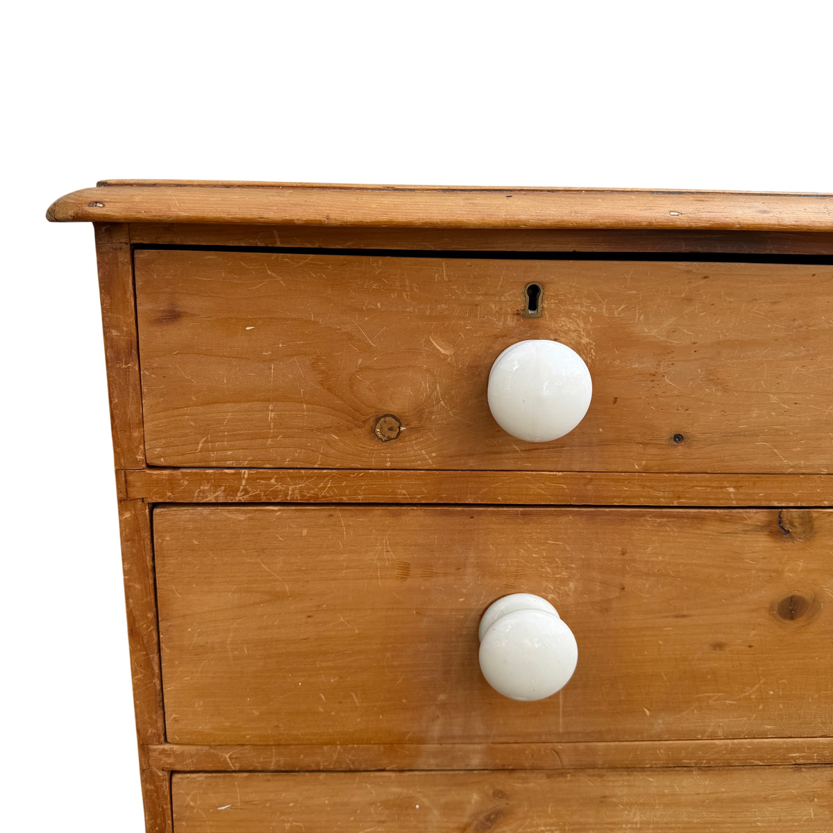 Lower drawers and turned feet of Victorian pine chest of drawers