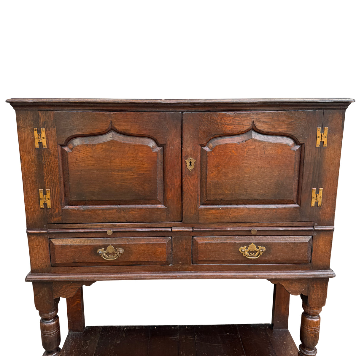 Front view vintage oak cabinet with arched panel doors and short drawers