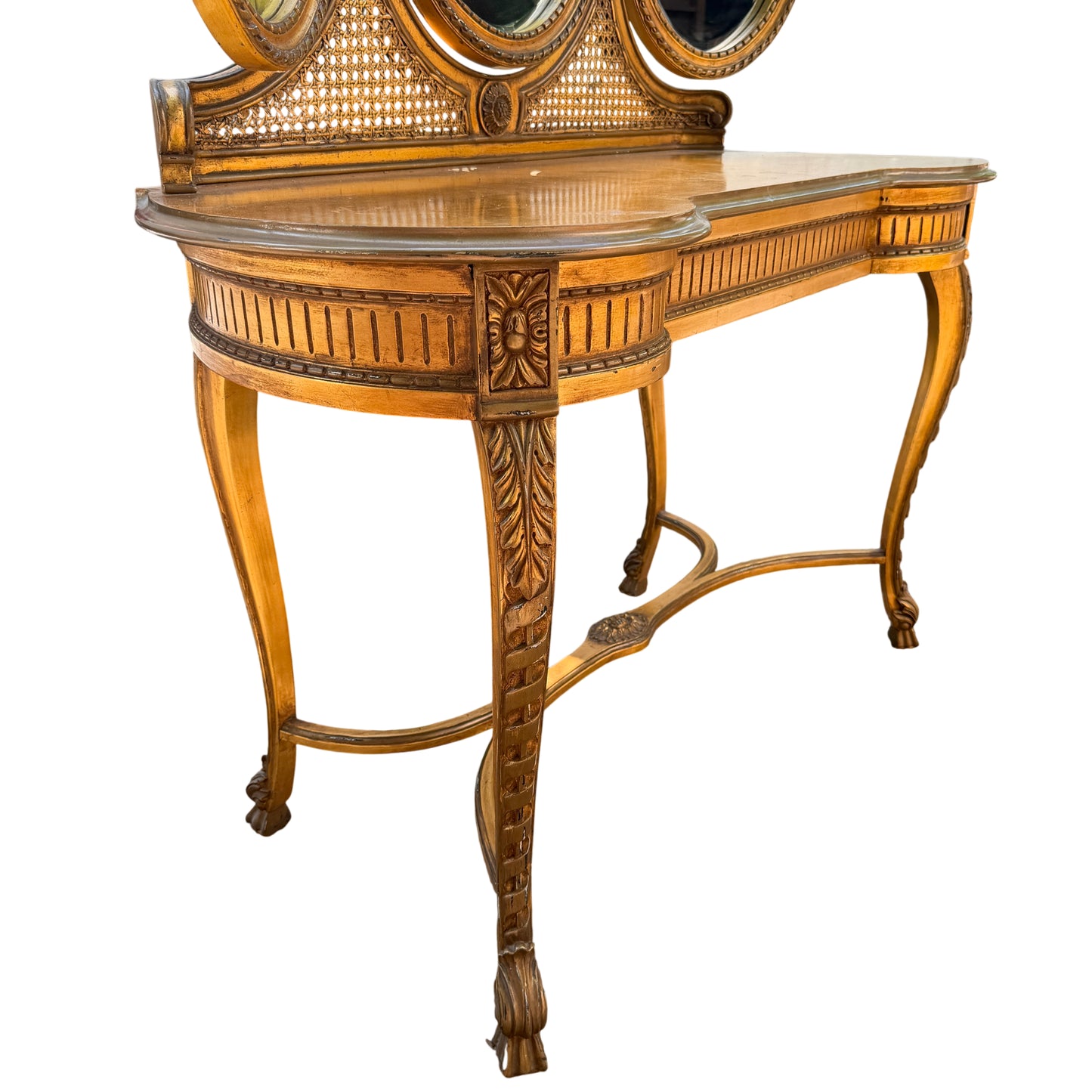 Three‑mirror vanity table in a gold lacquered finish from an angle