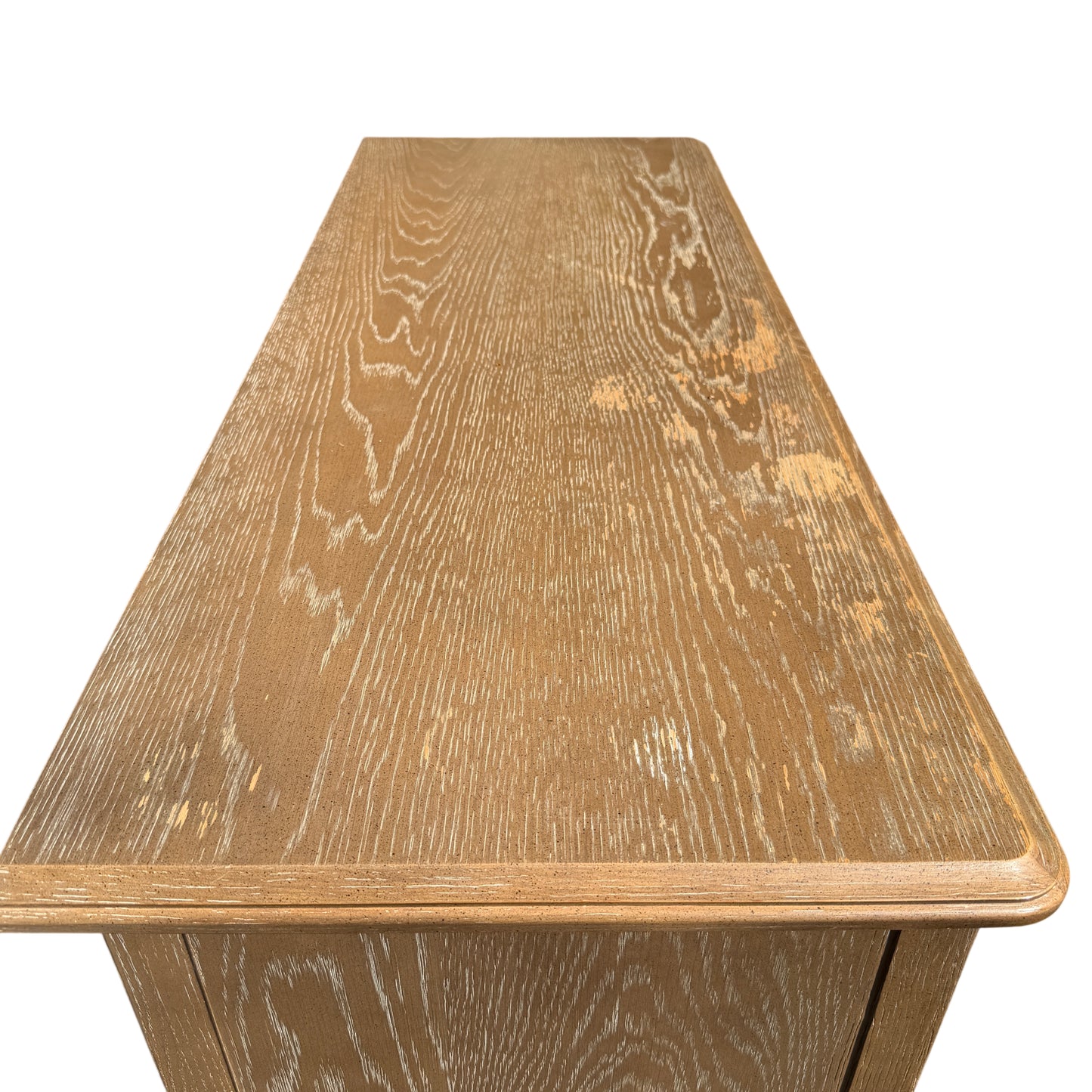 Detail of top edge and upper drawers on contemporary oak-effect chest with light surface wear