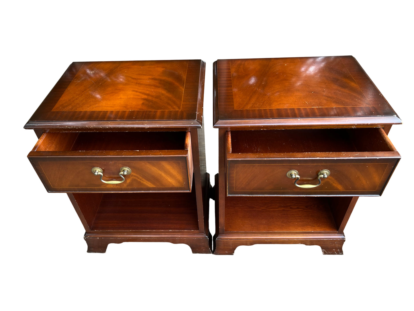 Matching pair of nightstands with figured mahogany veneer tops and inlaid border