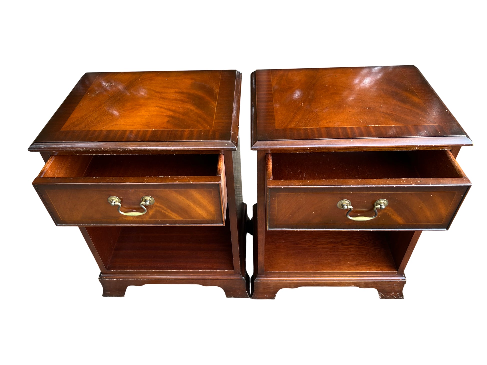 Matching pair of nightstands with figured mahogany veneer tops and inlaid border
