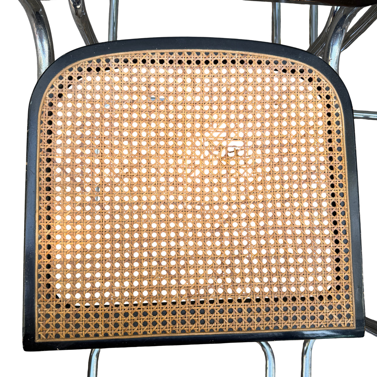 Close-up of woven cane seat showing pattern and natural discolouration on a Mid Century chair