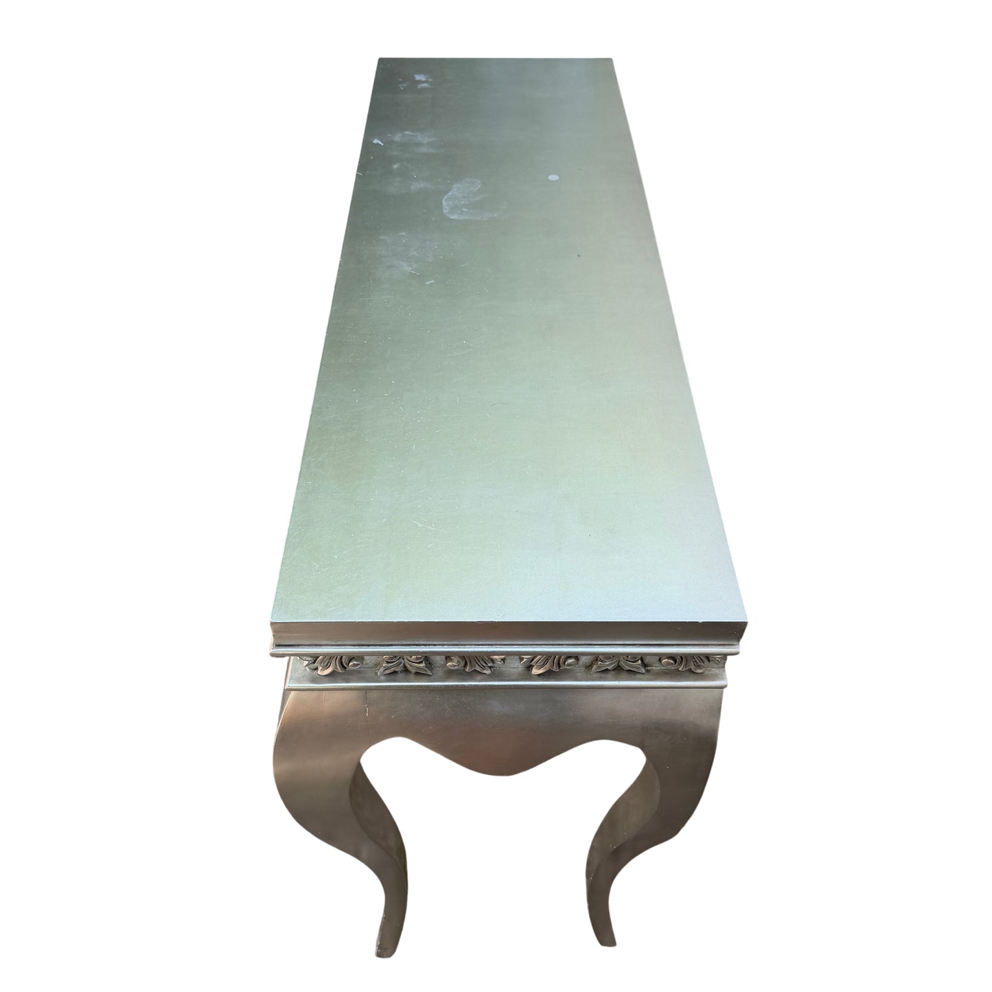 Angle view showing the table leg profile and silver painted finish on a console table
