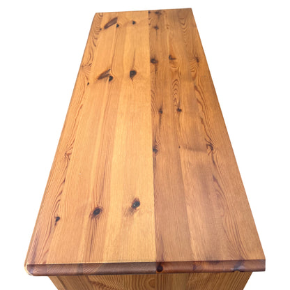Vintage wooden bookcase showing top shelf and panelled interior
