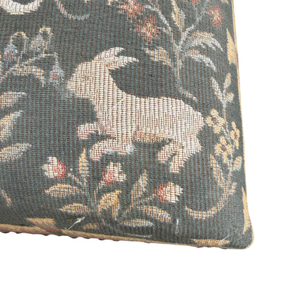 Tapestry footstool showing slight fading and surface wear on upholstery