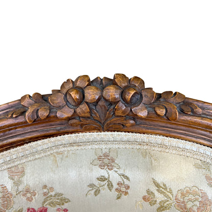 Pair of French-style upholstered armchairs with carved wooden frames seen from side