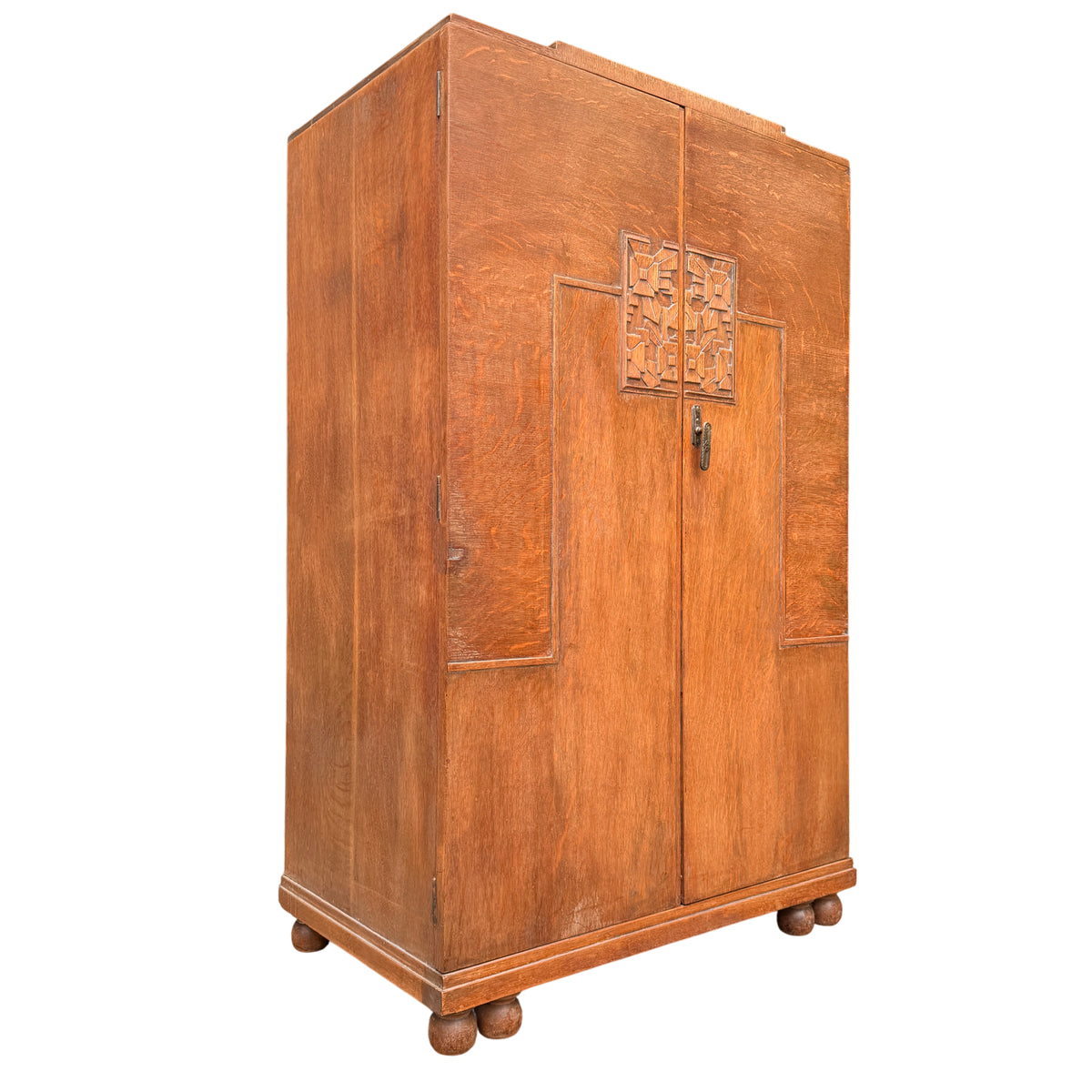 Art Deco oak linen press cupboard with carved central doors and bun feet