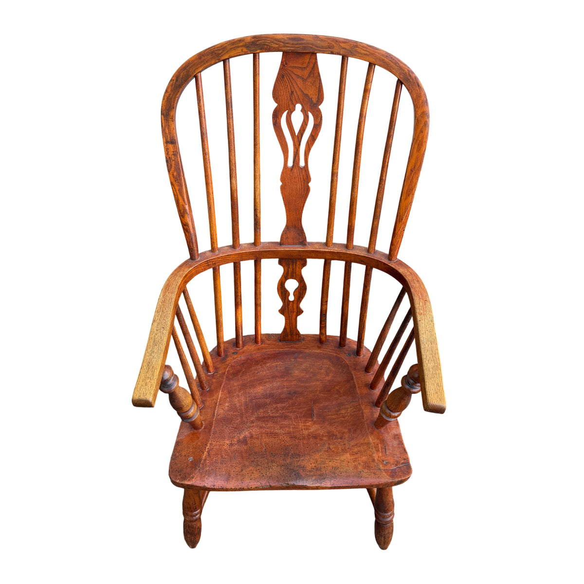 Front view vintage Windsor-style oak armchair showing carved centre splat and spindles
