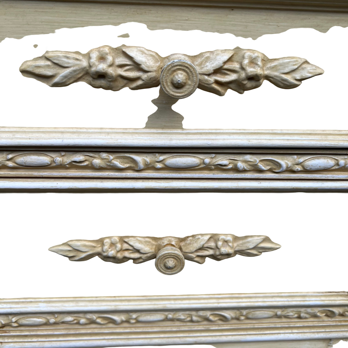 Close-up of carved floral drawer front and round wooden knob on bedside cabinet