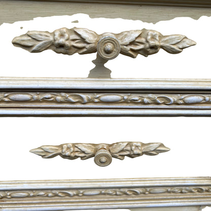 Close-up of carved floral drawer front and round wooden knob on bedside cabinet