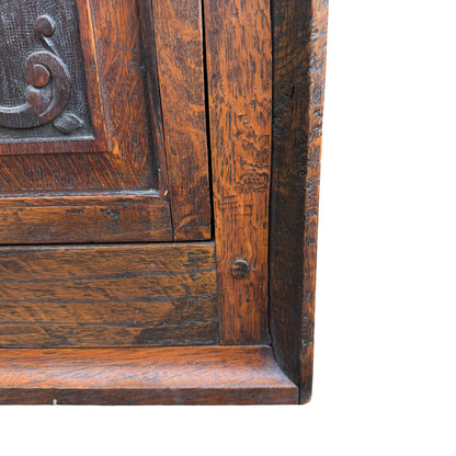 Base plinth and lower panel of small oak corner storage cabinet
