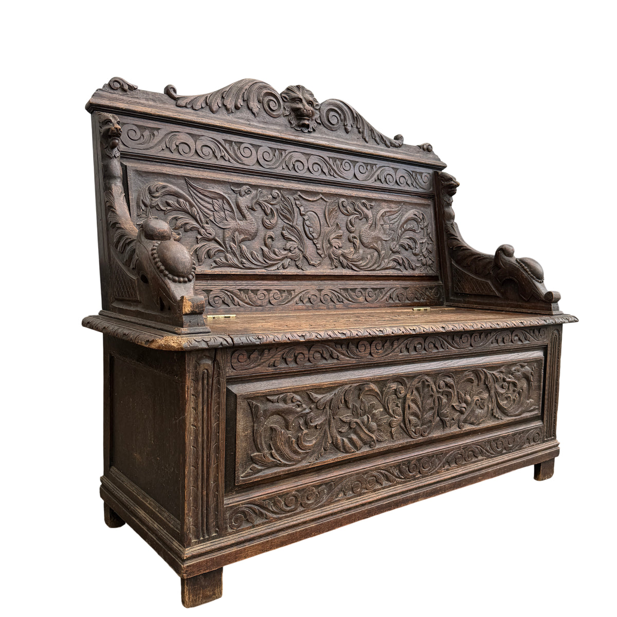 Victorian carved oak hall bench with lift-up storage seat and lion-mask cresting