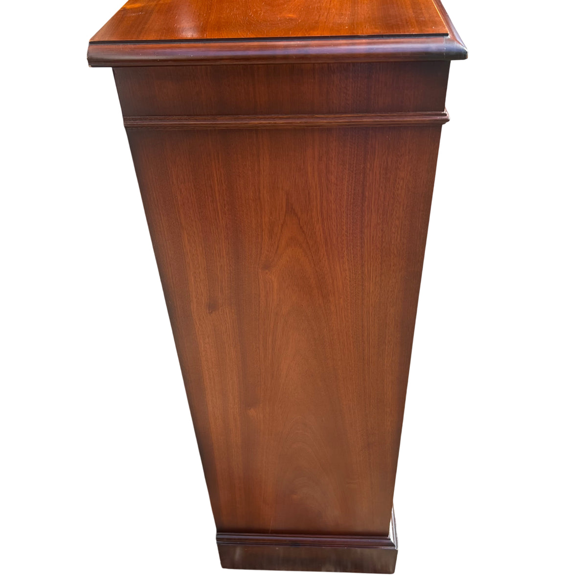 Top view of mahogany veneered bookcase showing moulded edge