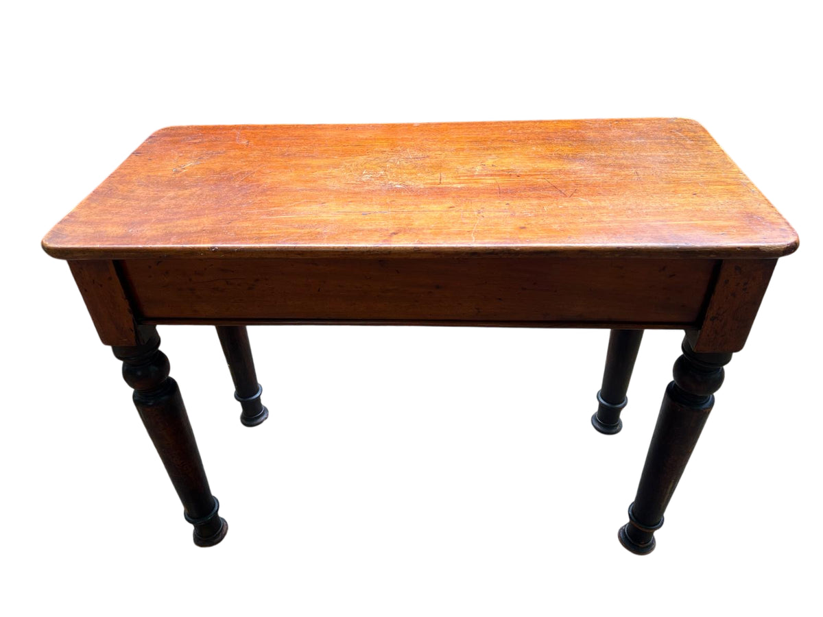 Side view of Victorian console table showing turned supports and apron