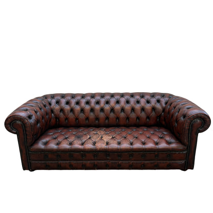 Front view brown leather Chesterfield sofa three seater with deep tufting