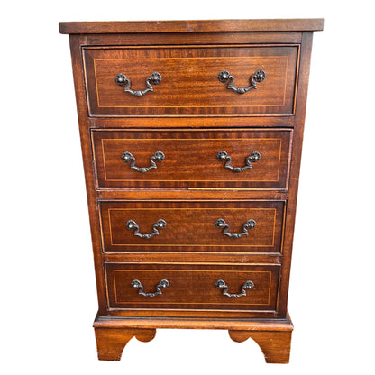 Narrow vintage mahogany veneer chest of drawers front view with brass drop handles and inlaid stringing