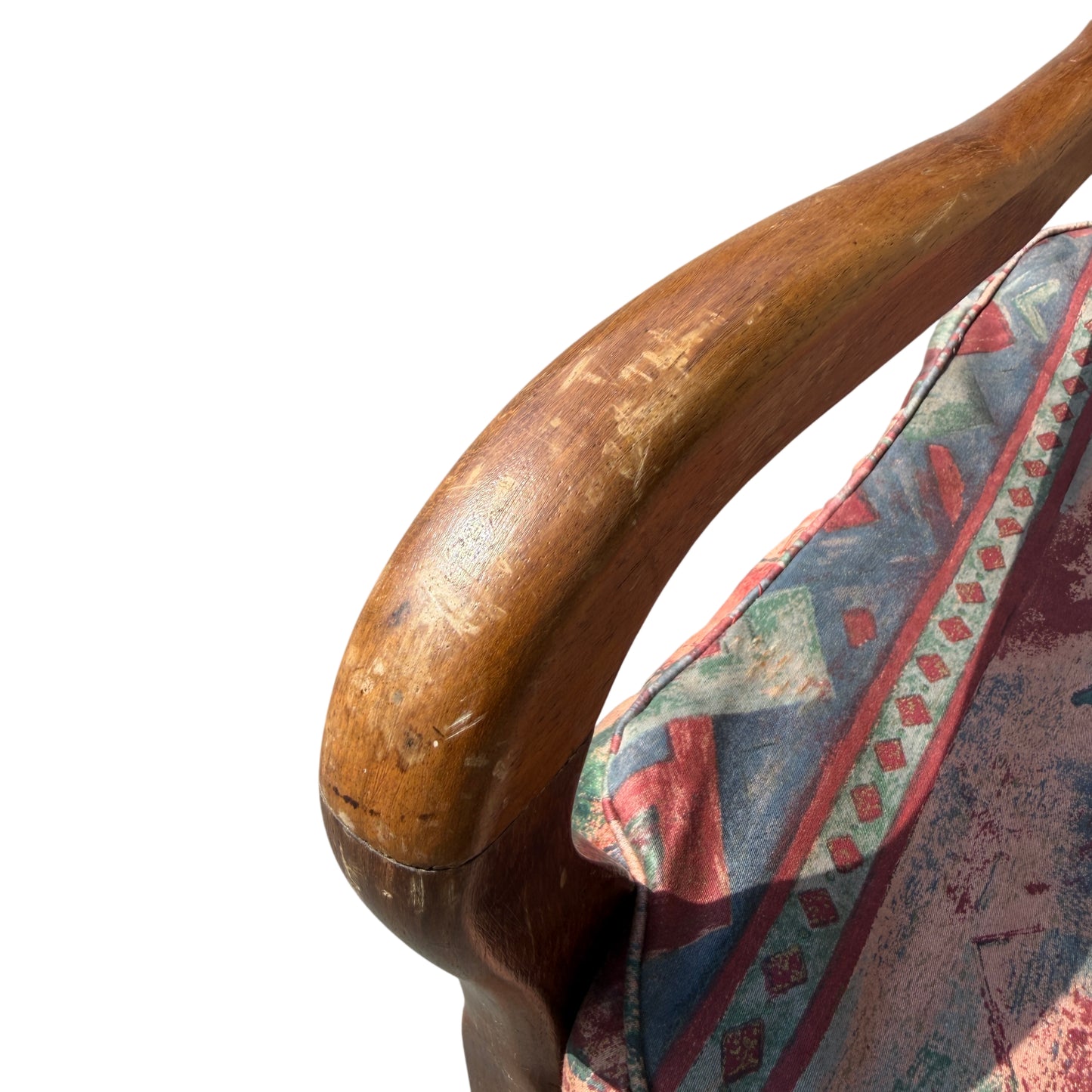Detail of patterned upholstered seat cushion on vintage wooden armchair
